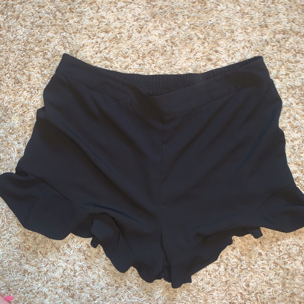 Women’s black ruffle bottomed shorts
